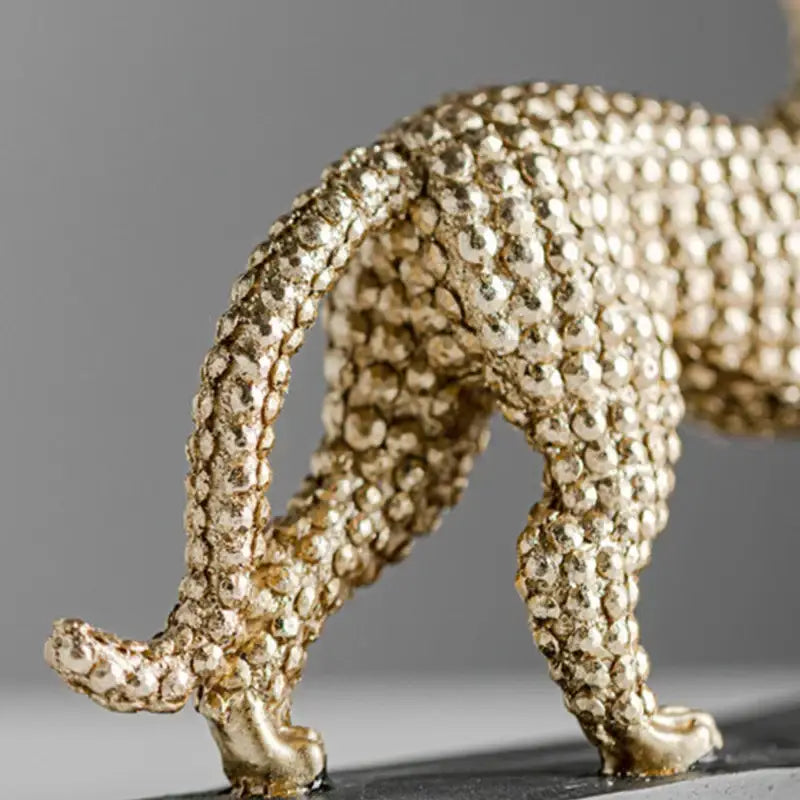 Modern golden leopard resin figurine with textured pebble surface for living room decor by decorbites golden leopard