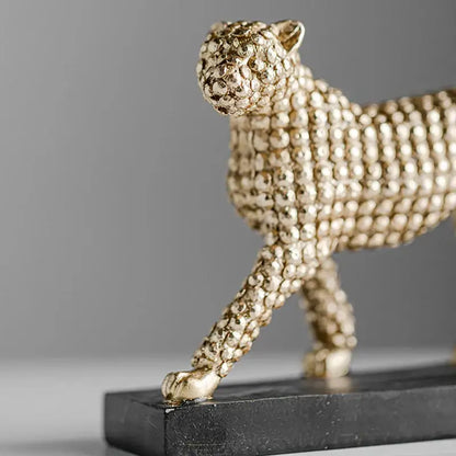 Golden leopard resin figurine with textured beaded surface on black base for modern living room decor by decorbites