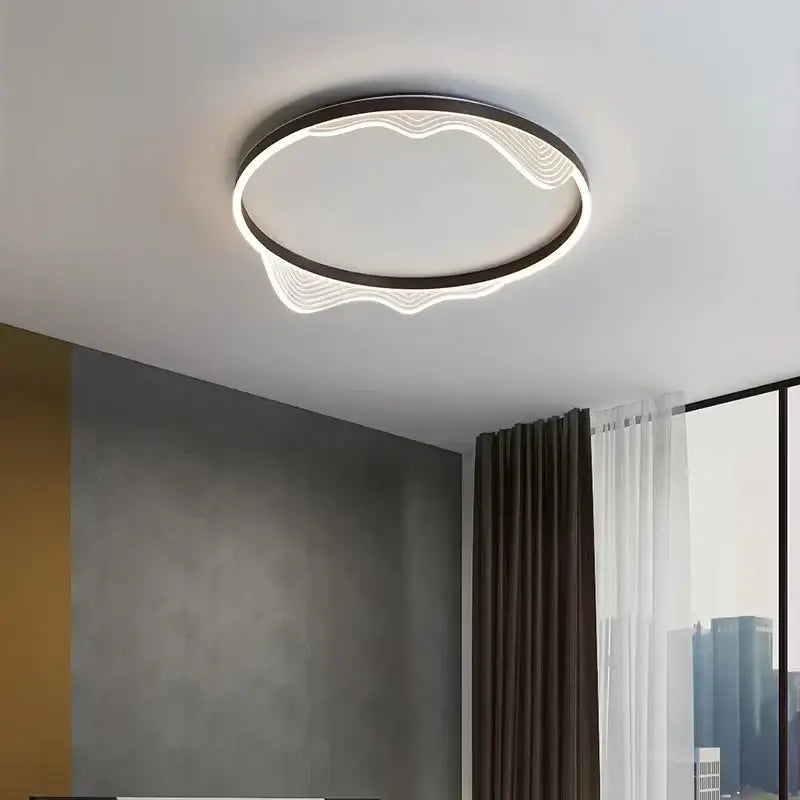 Modern circular ceiling lamp with sleek black frame and glowing white led wave patterns decorbites golden lustre ceiling light
