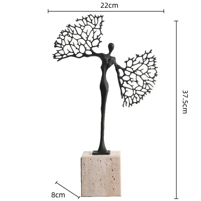 Black metal abstract figure sculpture with intricate coral-like wings on beige stone base for decorbites golden metal decor
