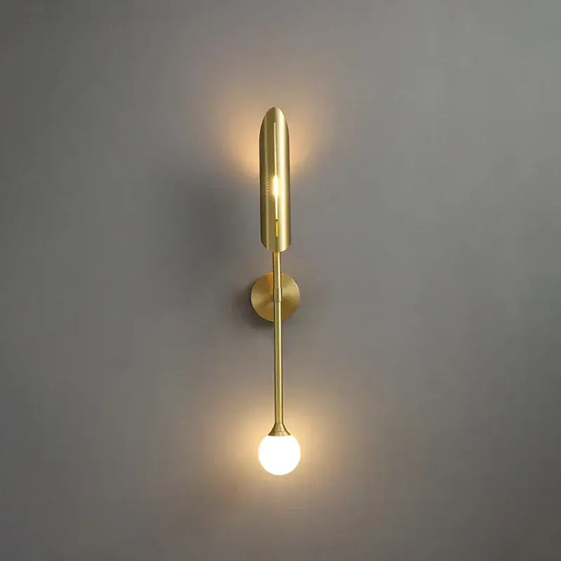 Modern golden metal led wall lamps with sleek elongated design featuring cylindrical upper element and spherical bulb base for decorbites golden metal decor