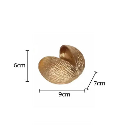 Modern golden nut shell ornaments desk decor featuring a textured glossy golden nut shell with spiral design