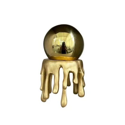 Modern golden octopus spherical ornament featuring a golden reflective crystal ball with dripping gold resin decorbites golden octopus