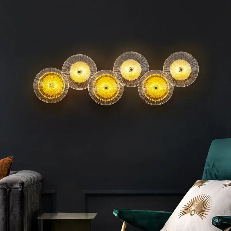 Modern golden radial crystal wall lamp featuring five translucent glass sconces with illuminated centers for living room decorbites crystal wall