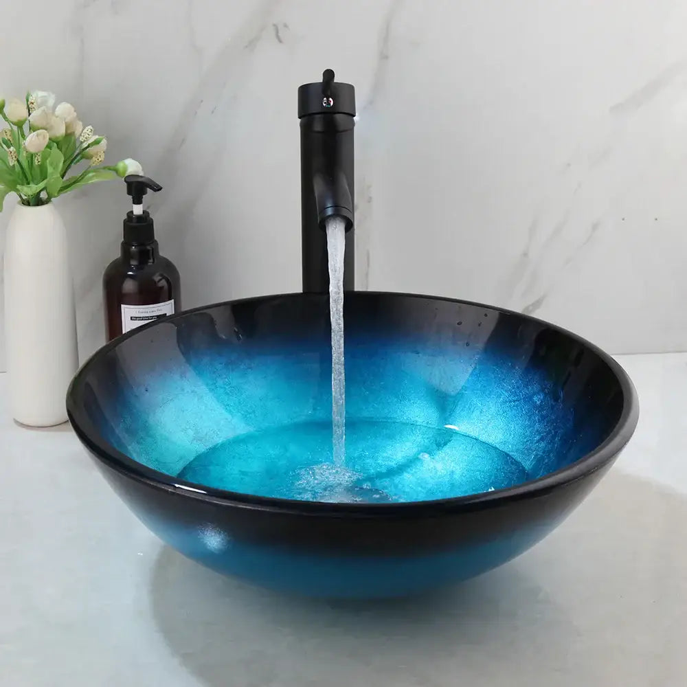 Modern gradient blue glass sink set featuring a vibrant decorbites blue glass sink with a sleek black faucet