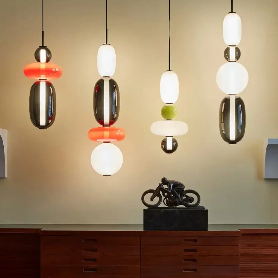 Modern gradient glass pendant light with stacked glossy glass and metallic spheres in black and white for dining room
