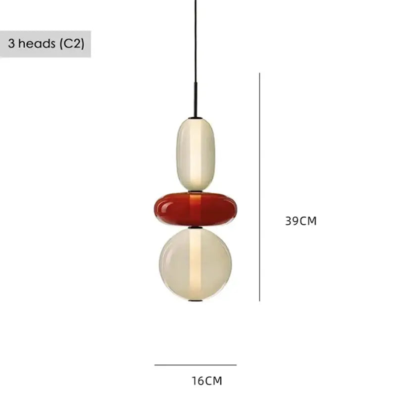 Modern gradient glass pendant light with three stacked orbs in cream, glossy red, and translucent cream for dining room