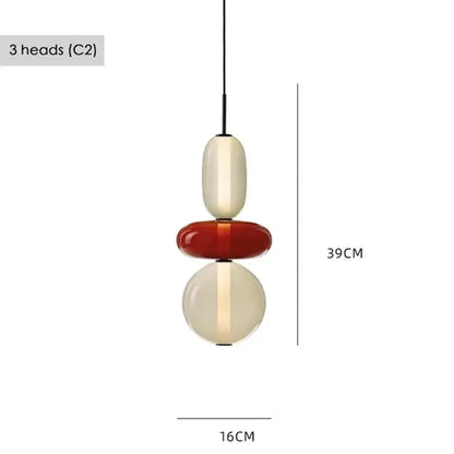 Modern gradient glass pendant light with three stacked orbs in cream, glossy red, and translucent cream for dining room