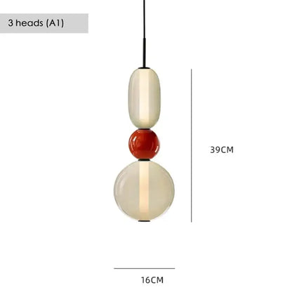 Modern gradient glass pendant light with three stacked cream, glossy red, and translucent orbs for dining room use