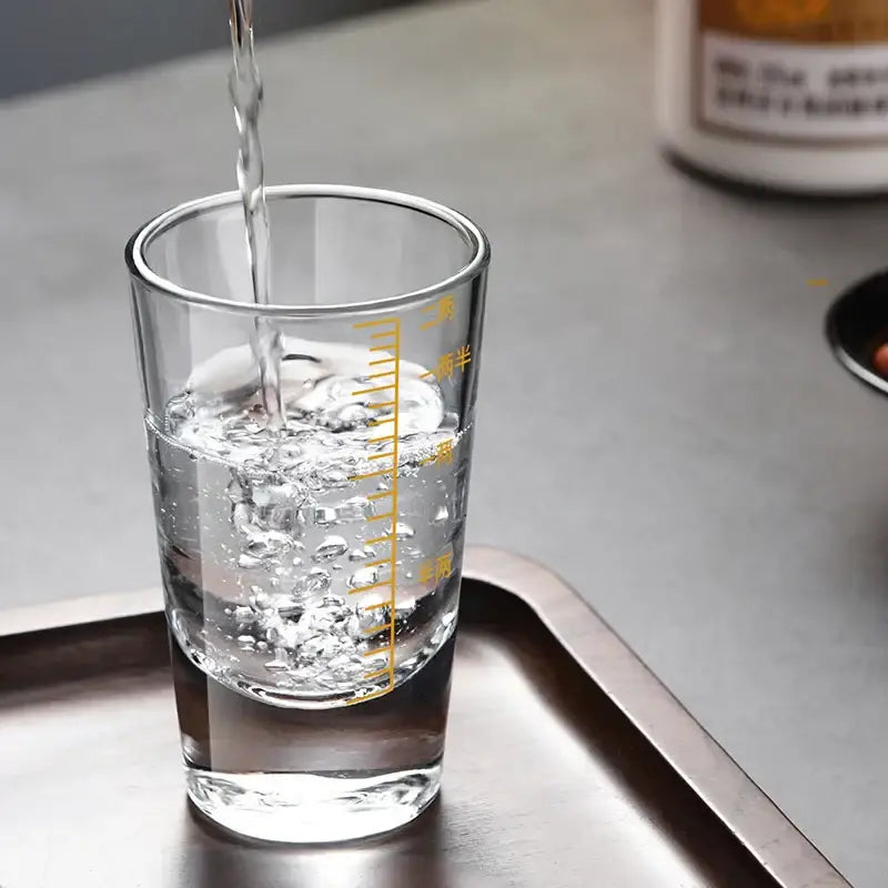 Clear glass spirit set measuring cup with yellow chinese markings for modern brandy cups and dining use
