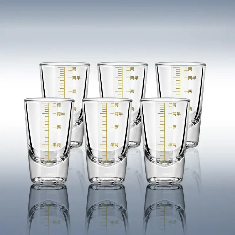 Clear glass spirit set brandy cups with gold-colored chinese measurement markings for modern dining use