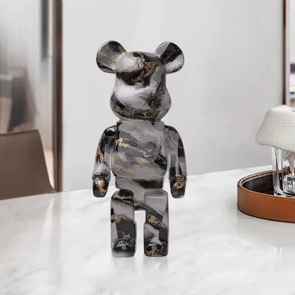 A sleek black and gold marble-patterned decorbites graffiti bear 27cm figurine used as a modern living room money jar