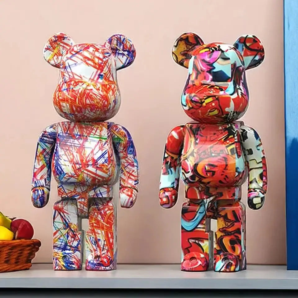 Two vibrant decorbites graffiti bear 27cm figurines with bold red blue and yellow glossy plastic surfaces used as money jars