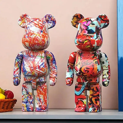 Two vibrant decorbites graffiti bear 27cm figurines with bold red blue and yellow glossy plastic surfaces used as money jars