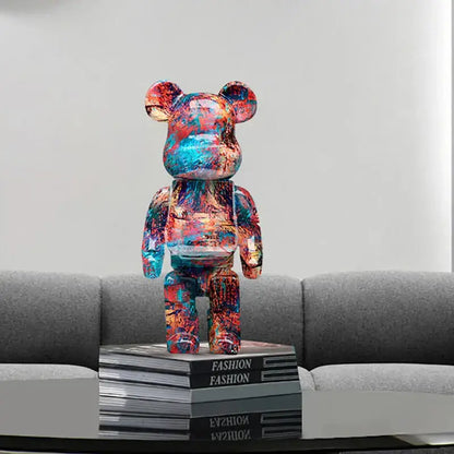 A vibrant glossy modern graffiti bear 27cm figurine with red blue and orange paint splatter used as a money jar decorbites graffiti bear