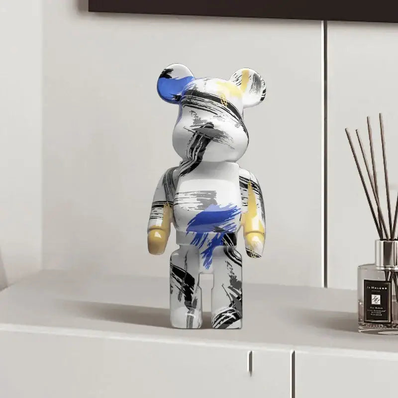 White bearbrick graffiti bear 27cm figurine with blue yellow black brushstrokes used as modern decorbites money jar