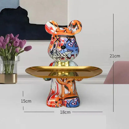 A vibrant decorbites graffiti bear figurine in colorful graffiti style with a gold tray for living room storage decor