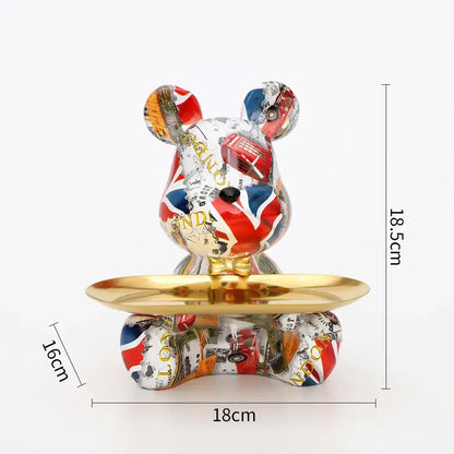 Glossy collage-patterned graffiti bear figurine with a gold tray on its belly for modern living room decor