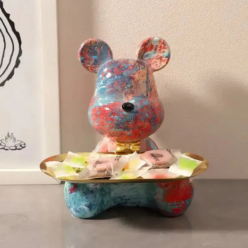 Colorful splattered-paint bear figurine with glossy finish and gold bow tie on golden tray modern graffiti bear decor