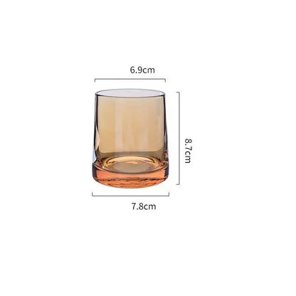 A sleek amber glass water tumbler with a sturdy base and rounded rim complements decorbites gray amber pitcher