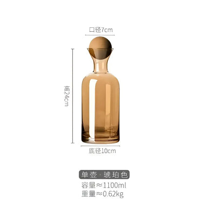 A sleek modern gray amber glass water pitcher with a smooth curved body and rounded golden wood stopper decorbites gray amber