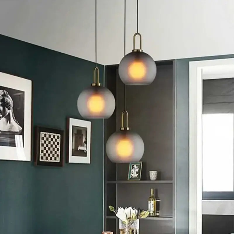 Modern gray and brass glass pendant light fixture with frosted globes for kitchen lighting pendant light design