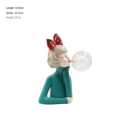 Modern gray and gold bubble girl statue night light featuring a teal ribbed sweater figurine with red polka-dot bow decorbites bubble girl