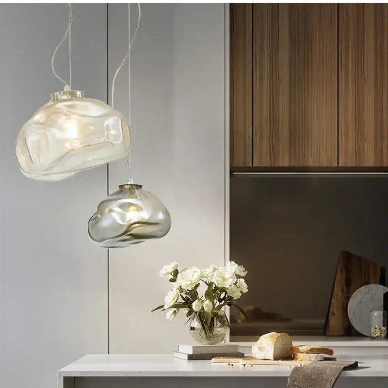 Two translucent gray cloud glass pendant lights hang from the ceiling in a modern living room decorbites cloud glass fixture