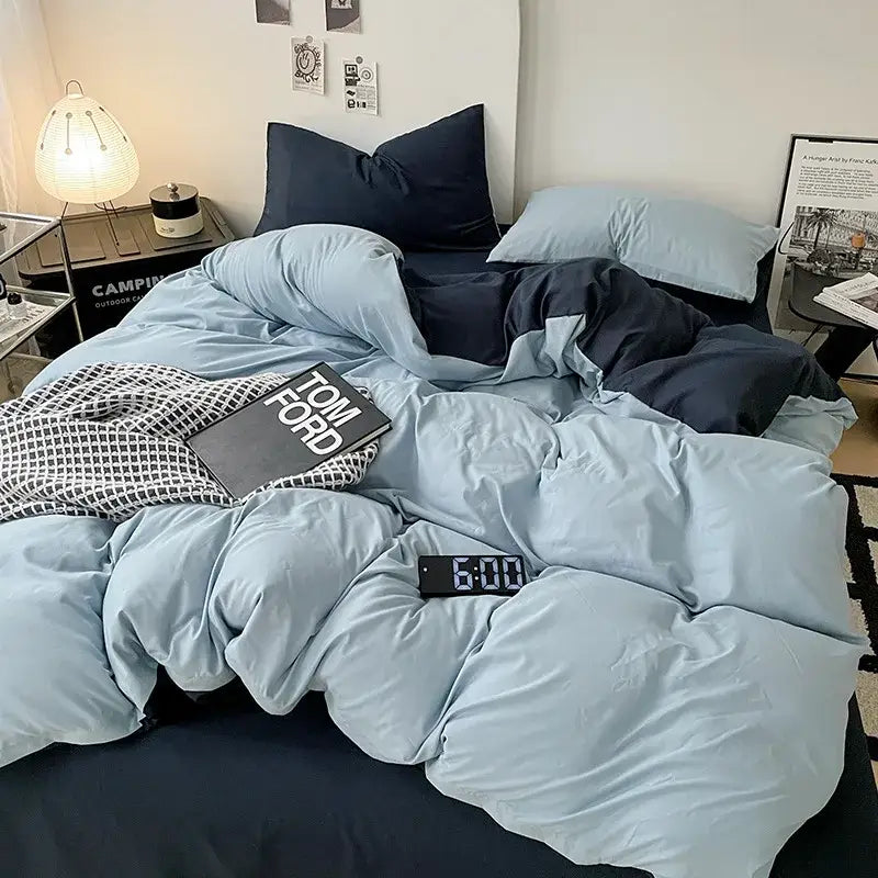 Modern gray comforter cover set featuring a light blue plush duvet cover with matching pillows and a dark navy bedsheet