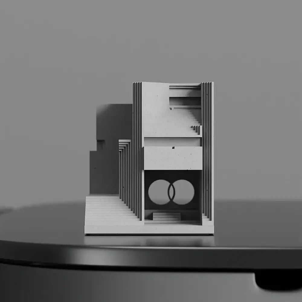 Minimalist white architectural model with layered panels and circular motif for modern gray concrete brian family cemetery decor