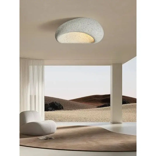 A modern gray concrete cream ceiling lamps chandelier featuring a half-moon shape with warm interior glow for decorbites cream ceiling