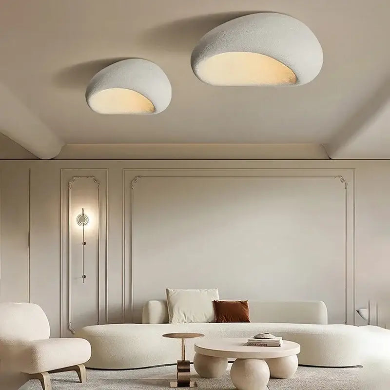 Two modern off-white decorbites cream ceiling lamps with cloud-like design and warm interior glow for bedroom use