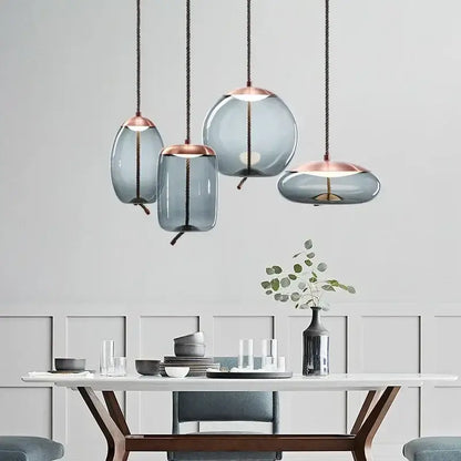 Modern gray glass chandelier knot pendant with frosted gray shades and rose gold accents for dining room lighting