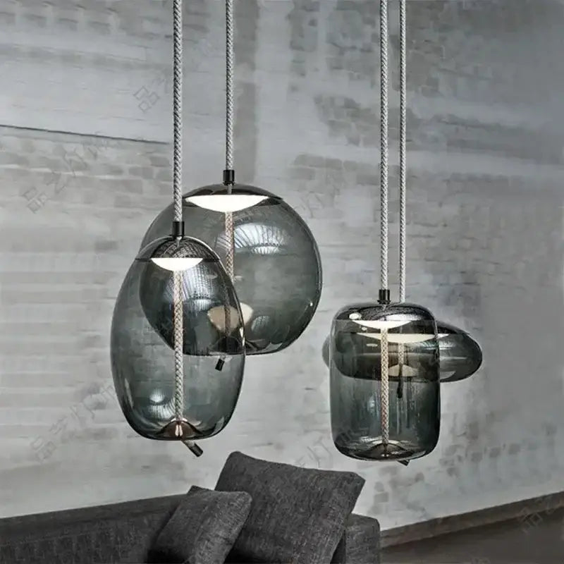 Modern gray glass knot pendant chandelier light with sleek organic shapes and metallic rope cords for dining room