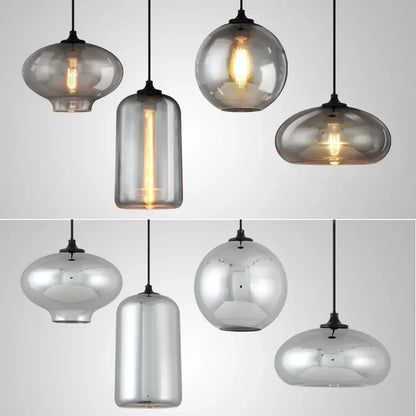 Set of 4 modern gray glass pendant lights with frosted and mirrored finishes and exposed filament bulbs for dining room