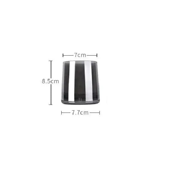 Modern gray glass water pitcher with stainless steel lid and sleek cylindrical glass candle holder with black and silver stripes