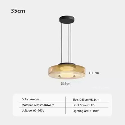 Modern gray and green tiered glass pendant light with amber-colored glass pendant and sleek black hardware for dining room