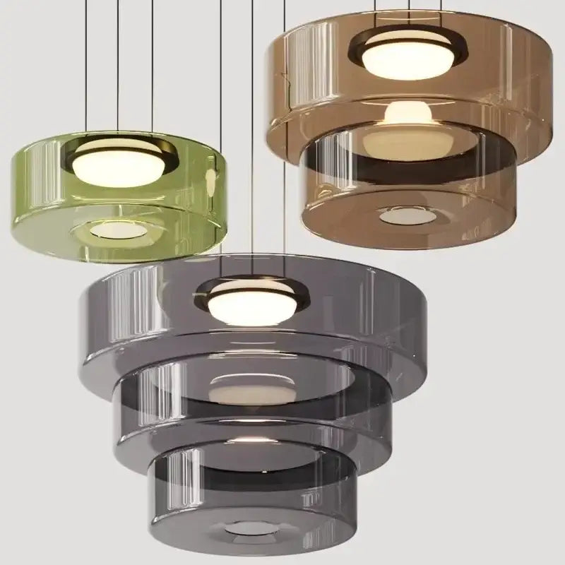 Modern gray and green tiered glass pendant light with translucent amber and circular illuminated centers for dining room