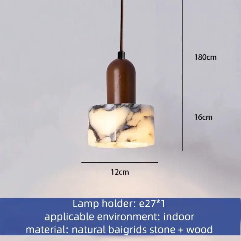Modern gray marble natural stone pendant light with warm glowing circular shade and cord pendant installation for dining room