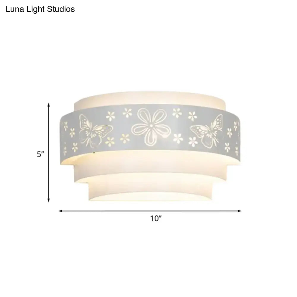 Modern gray metal wall sconce with flower-patterned etched frosted glass shades for warm living room lighting