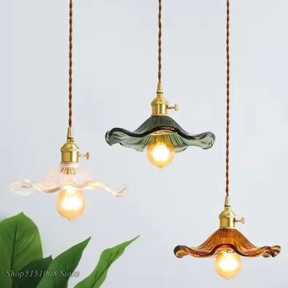 Three colorful glass pendant lights with green and amber ruffled shades brass fixtures and twisted cord pendant installation