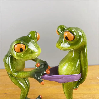 Modern green and orange leggy frog couple figurine made of resin with playful poses for living room decorbites decor