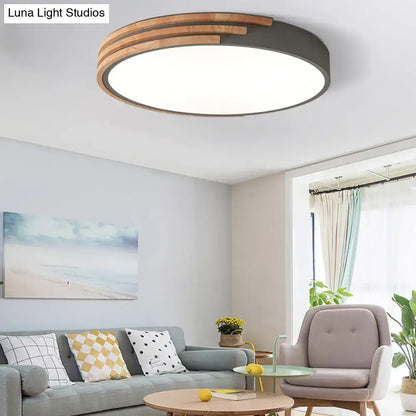 Modern round flush mount ceiling light by decorbites with dark metal frame and concentric wooden slats in grey and white