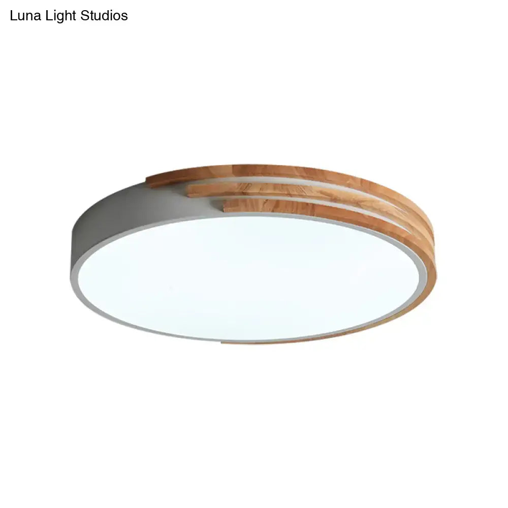 Modern round flush mount ceiling light with matte gray concrete base and warm wood slats by DecorBites™