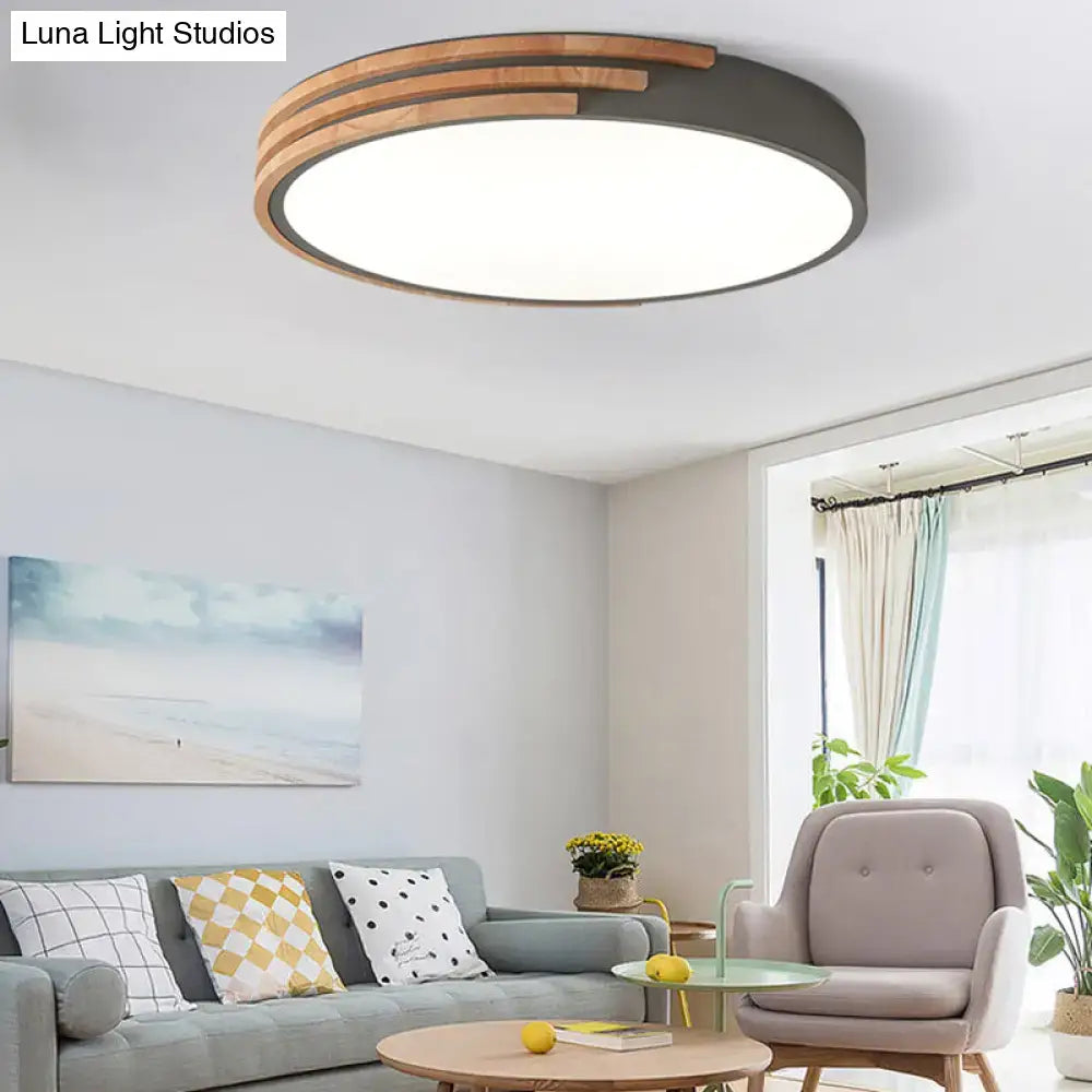 Modern round flush mount ceiling light with a grey metal frame and concentric wooden slats by decorbites
