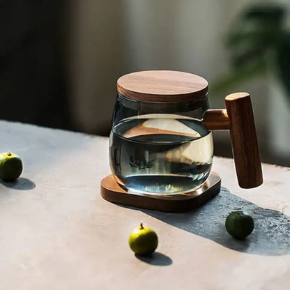 Clear glass teapot with wooden lid and wood handle on wooden coaster from decorbites glass tea cup kitchen set