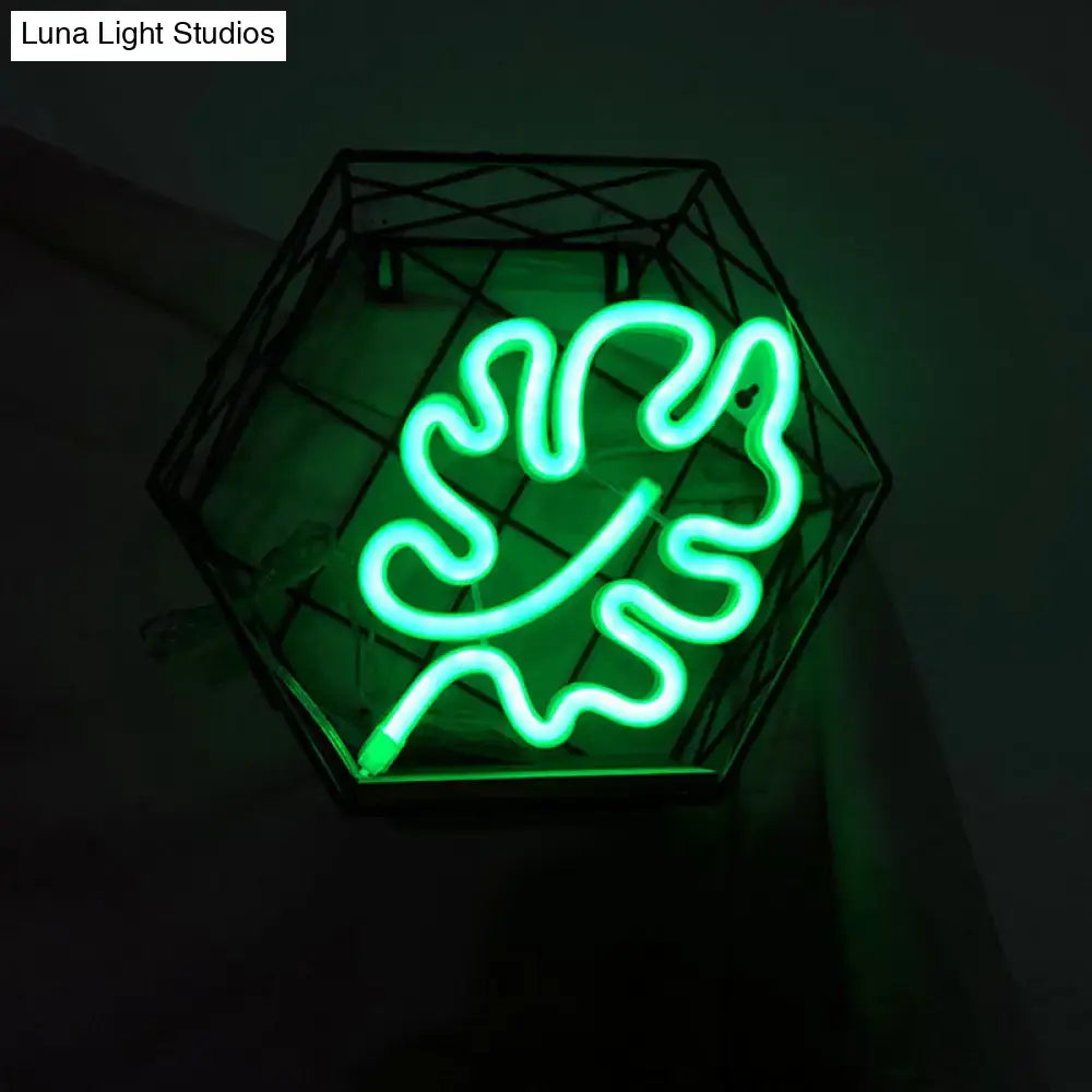 A modern green leaf neon sign itty bitty wall light with remote control encased in a black hexagonal wireframe