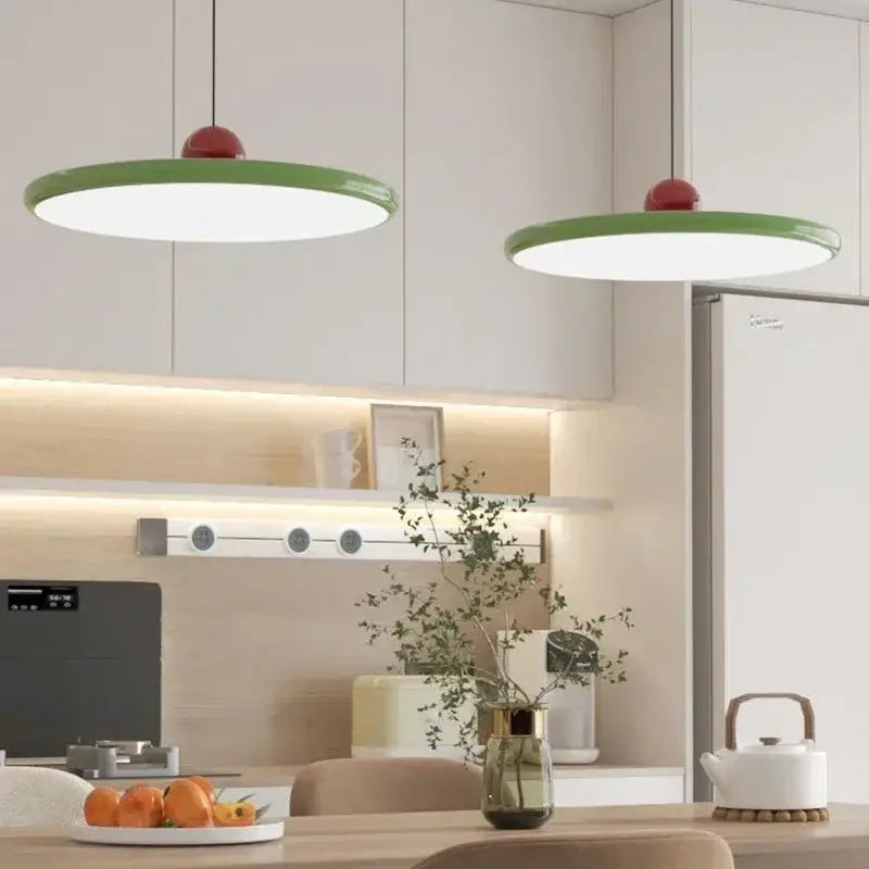 Modern green and red pendant light with graceful silhouette and led bulbs hanging from the dining room ceiling