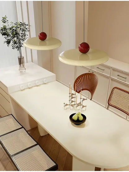 Cream-colored pendant light with glossy red spherical accents featuring led bulbs and a graceful silhouette for dining room
