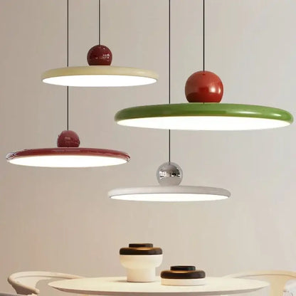 Modern pendant light with red and green circular flat shades and glossy accents featuring led bulbs for dining room